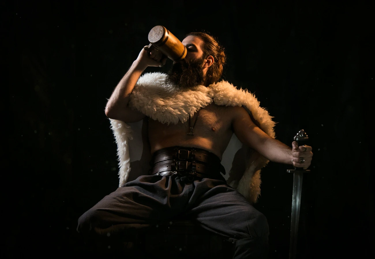 A Viking man drinking mead, highlighting the cultural significance of honey-based beverages in the Viking era.