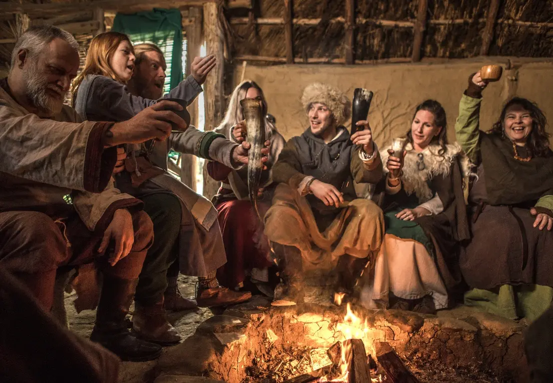 A Viking family enjoying a drink together, symbolizing traditional feasts and what kind of candy did Vikings eat during celebrations.