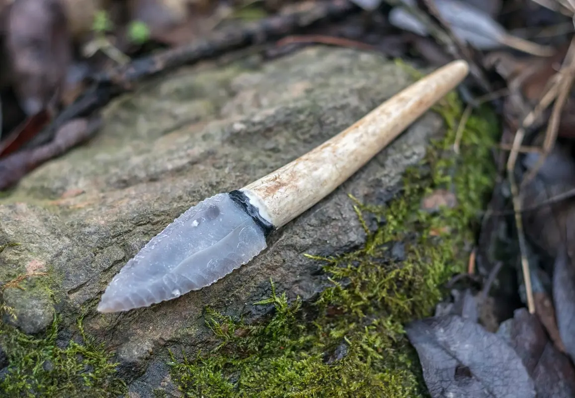 Native Americans using knife artifacts for hunting and crafting in ancient times.